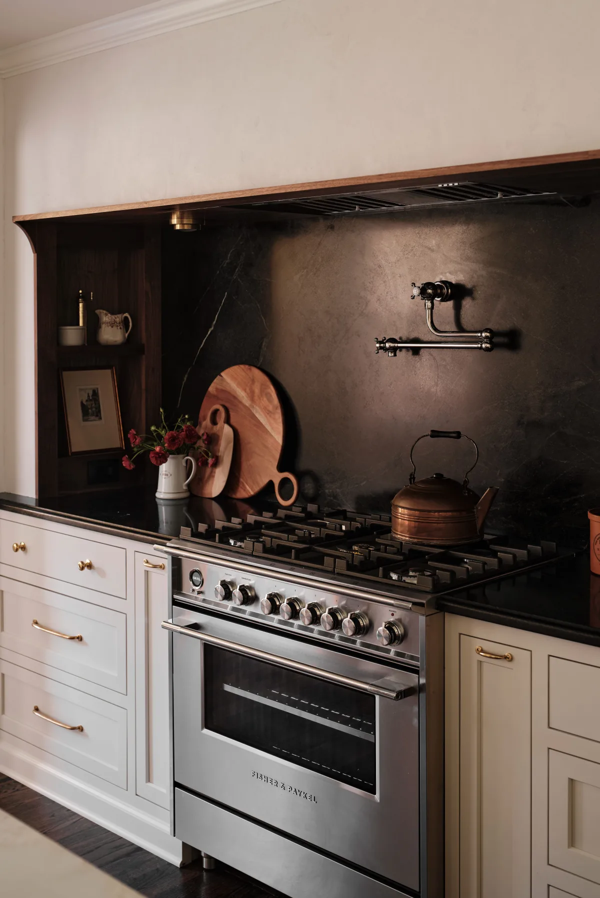Kitchen alcove with built-in banquette, round table, and pendant light