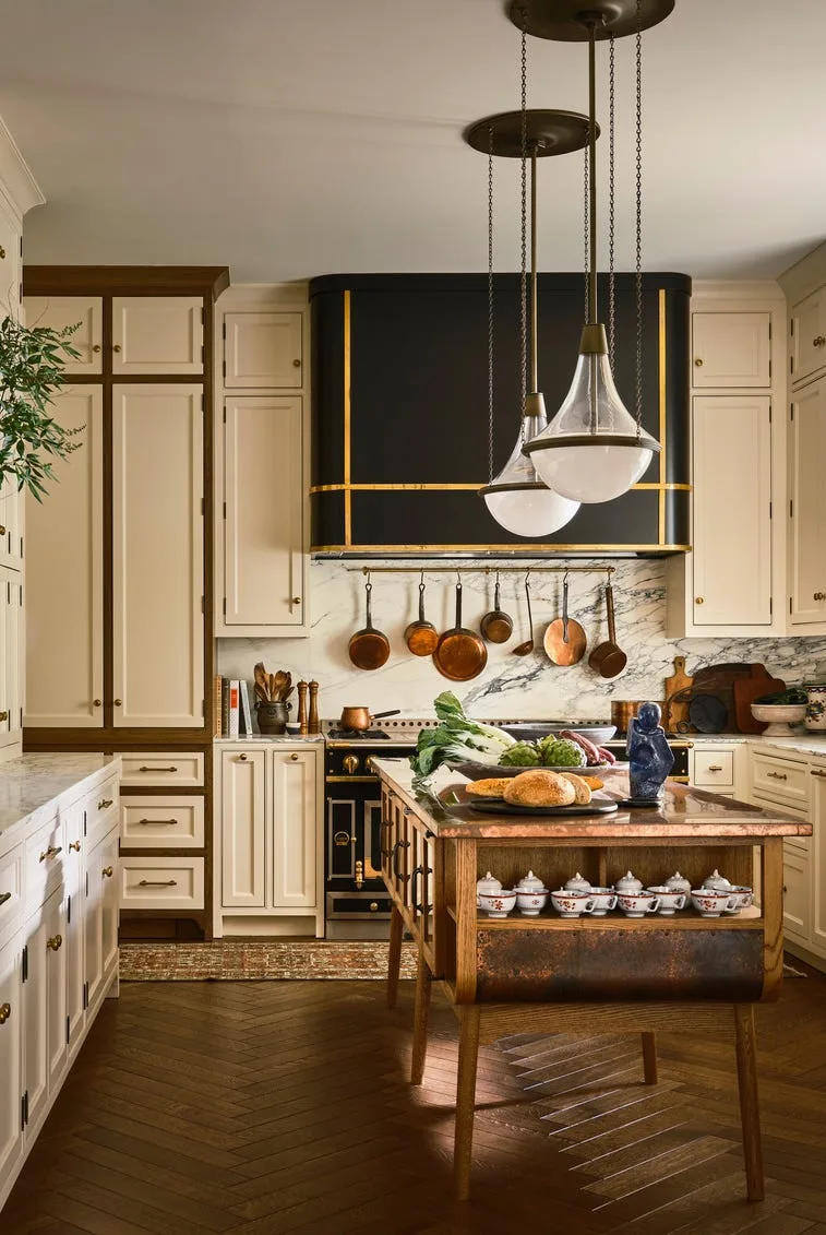 Kitchen in a Texas family home with white cabinets and marble backsplash