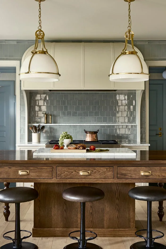 Kitchen in Minneapolis home with green cabinets and brass pulls