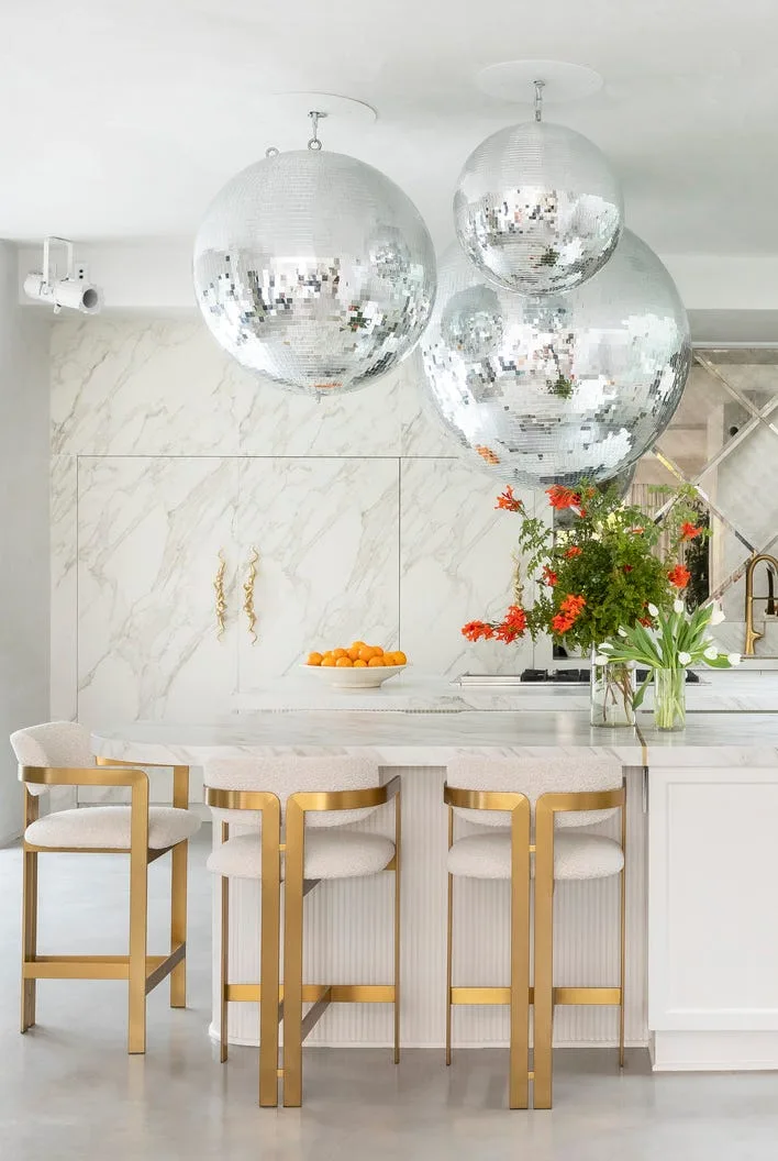 Kitchen in Venice Beach home with black cabinets and gold accents
