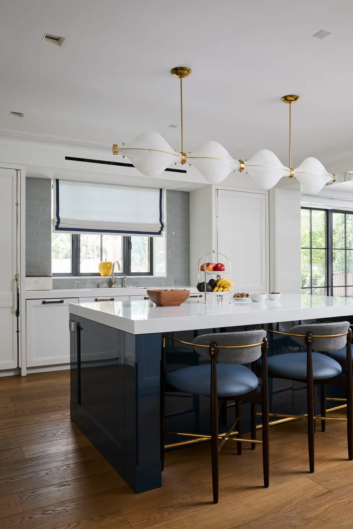 Kitchen with blue lower cabinets, white uppers, and patterned tile backsplash