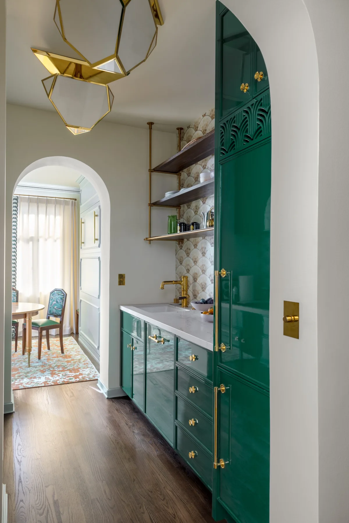 Kitchen with white cabinets, subway tile, butcher block countertops, and pot rack